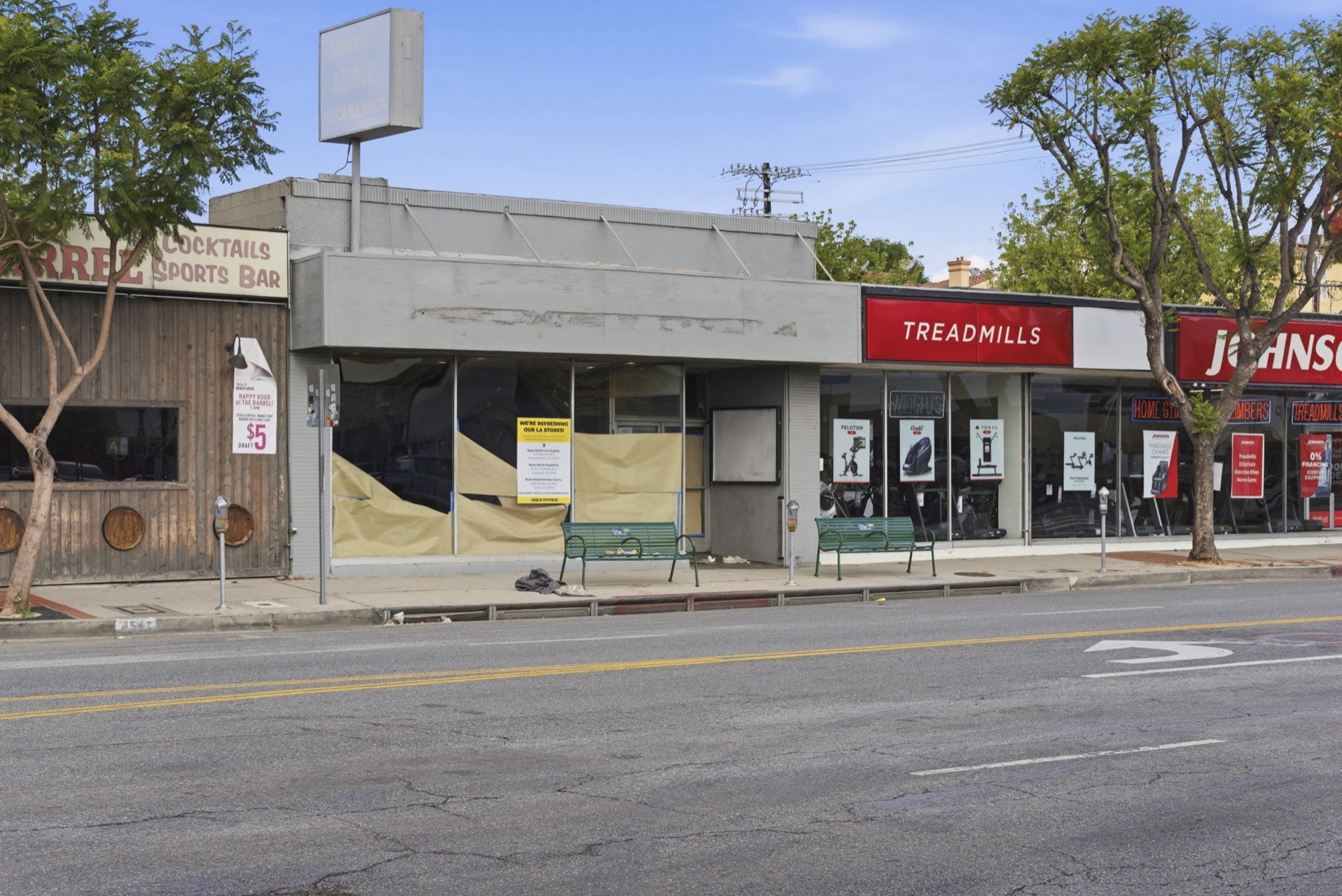 Close view of the 4553 Van Nuys Blvd storefront facade with papered windows ready for tenant signage
